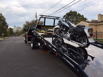 Our flatbed towing experts in Farmingdale, NY, are towing a motorcycle.